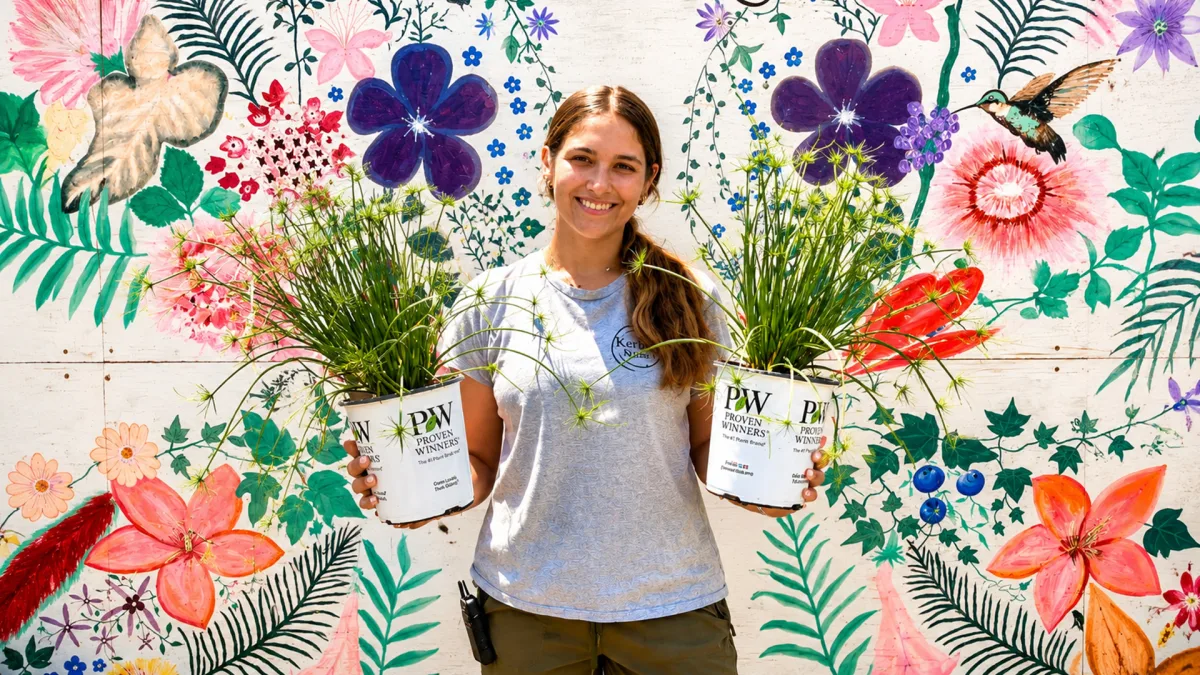 Kerby's Nursery staff member holding houseplants, from Guide to Florida's Get Your Green On roundup